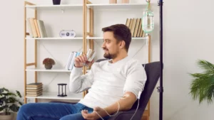 A man taking Post travel recovery from the IV drip